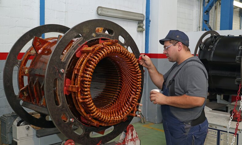 The almost finished motor housing is painted by hand