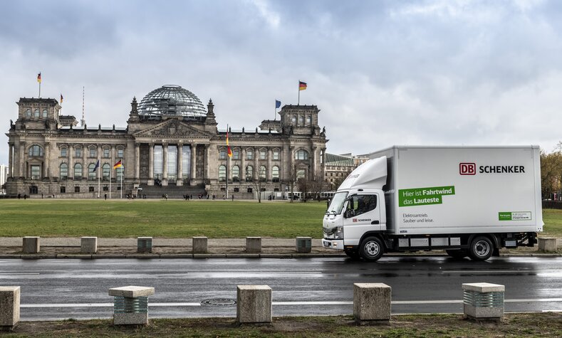 An electric truck in front of the Reichstag building in Berlin.