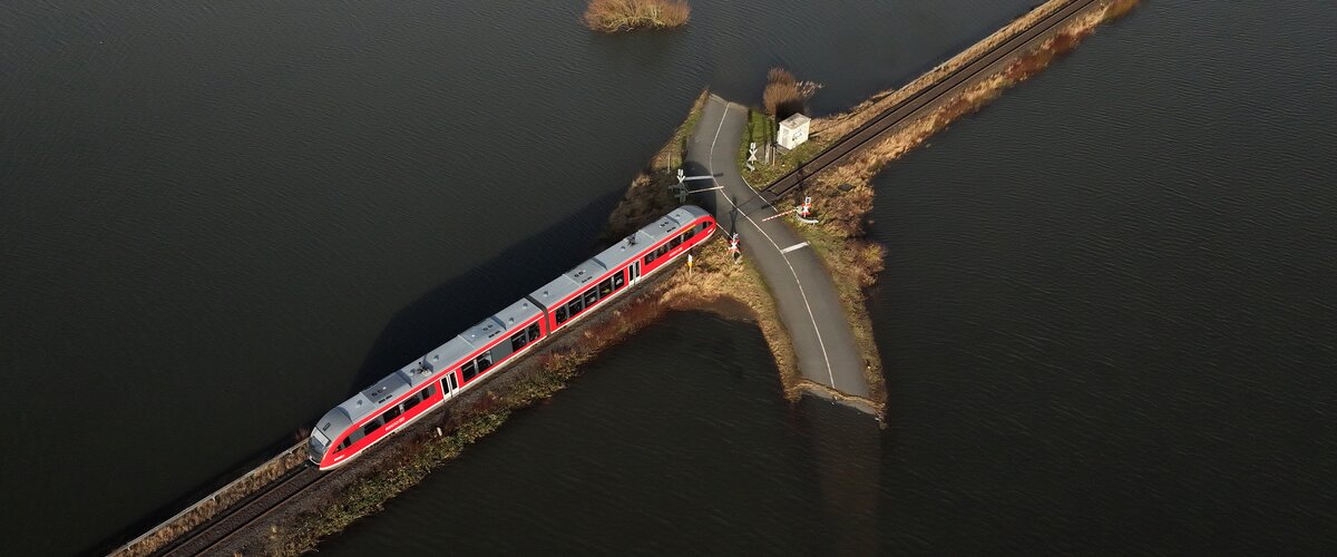 Eine Luftaufnahme von überschwemmten Gleisen und Straßen bei Hochwasser an der Nidder. | © Deutsche Bahn AG / Oliver Lang