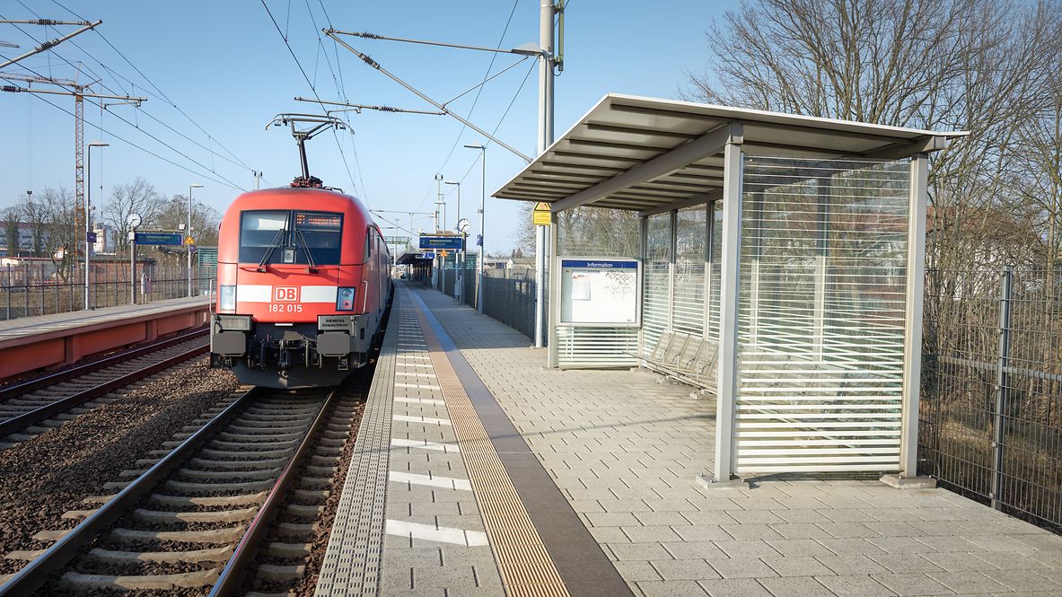 Ein Zug hält an einer Bahnstation. 