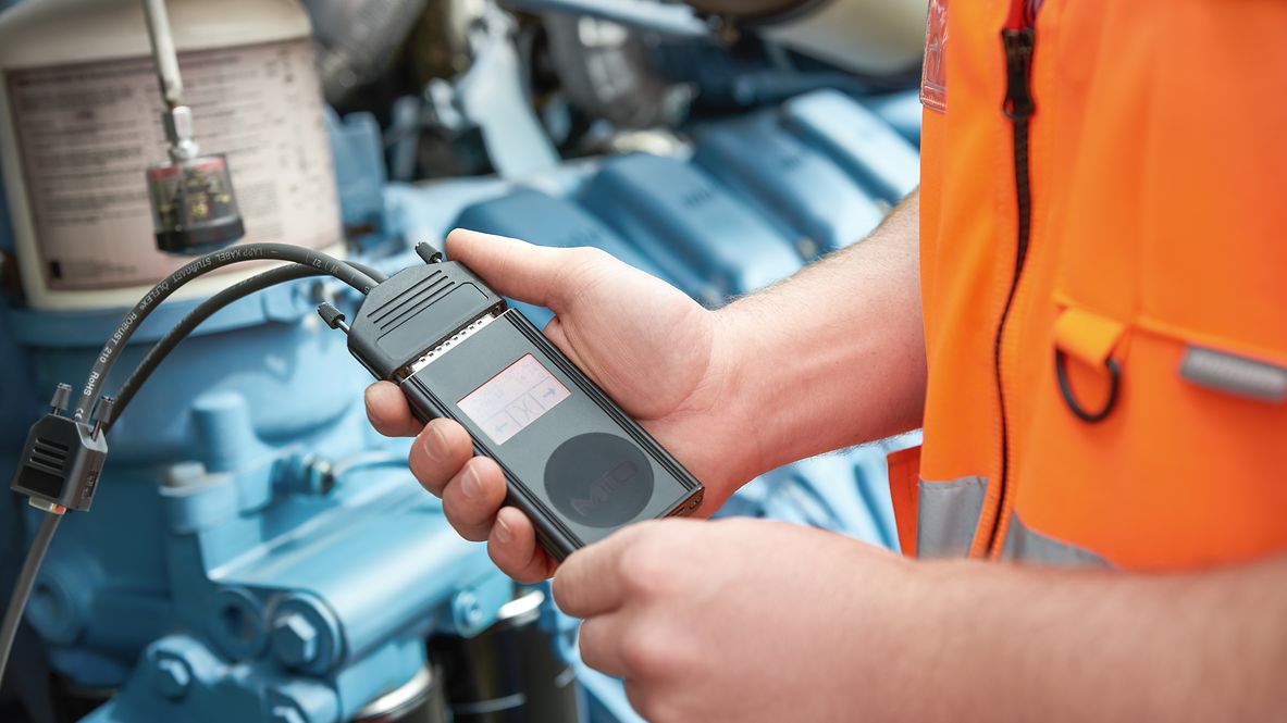 Ein Mitarbeiter führt mit dem Datenflasher das Tuning der Lok durch.