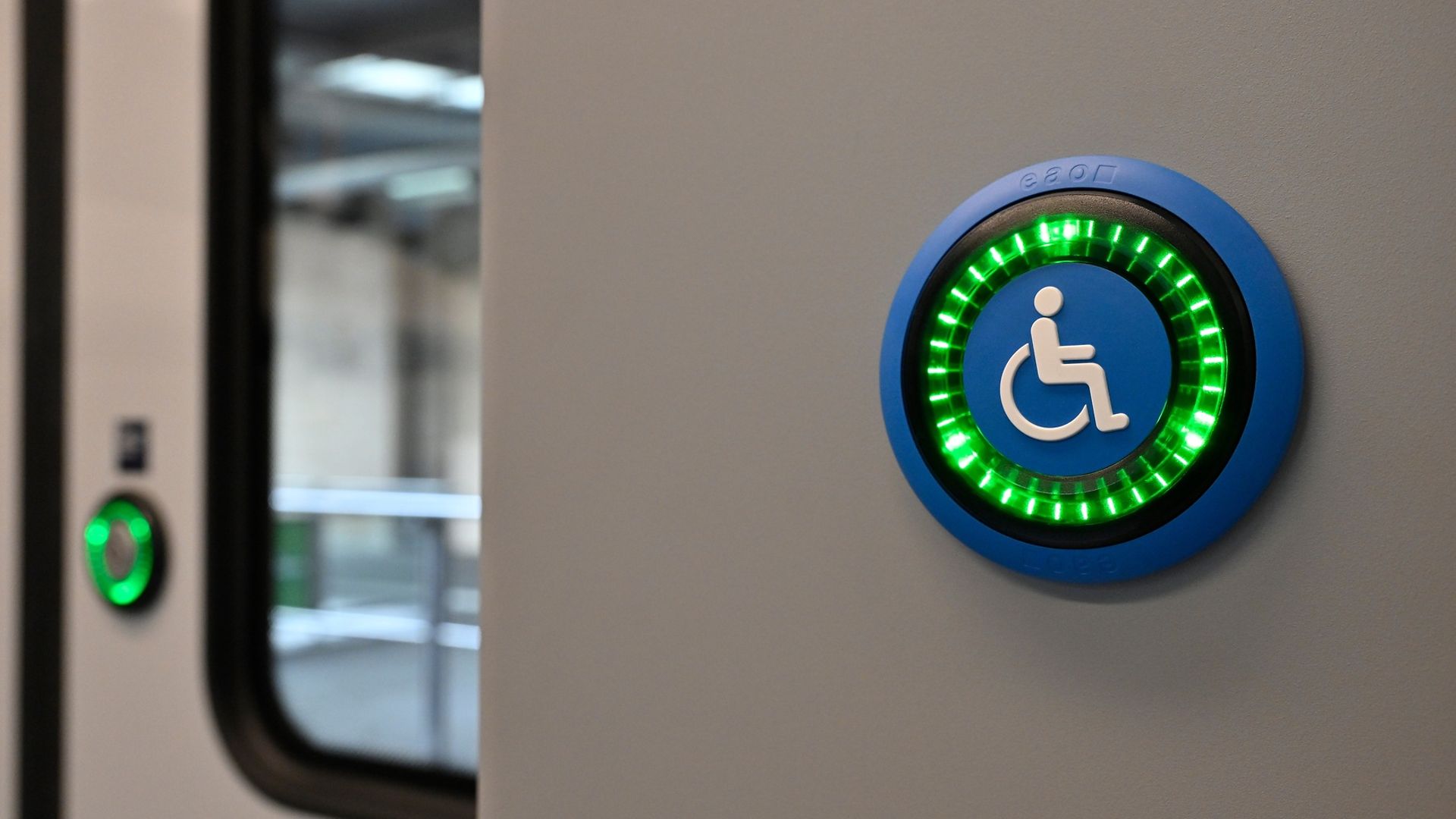 Blauer Taster mit einer Abbildung eines Rollstuhls im Zug 