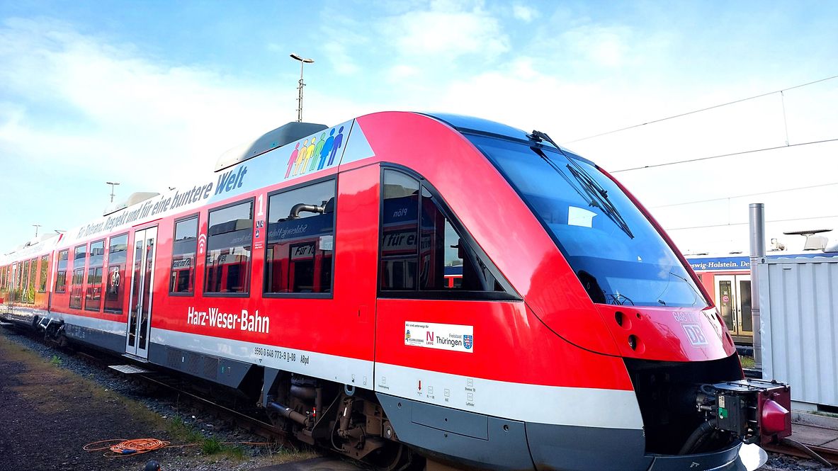 Ein bunt folierte Regionalzug auf der Schiene