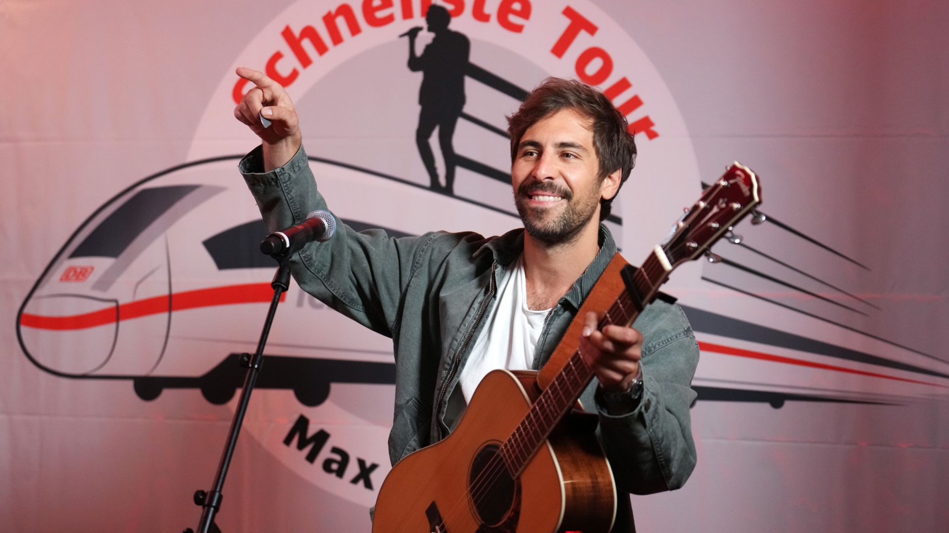 Sänger Max Giesinger mit Gitarre bei einem Bahnhofskonzert