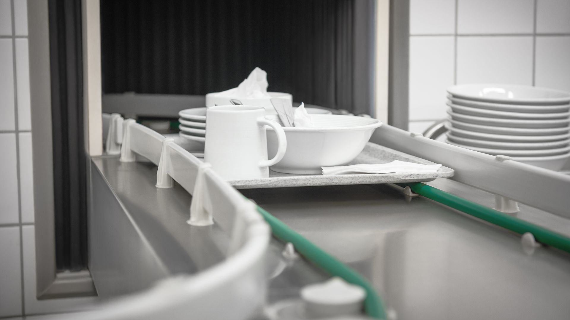 Dishes on a tray in a dishwashing system