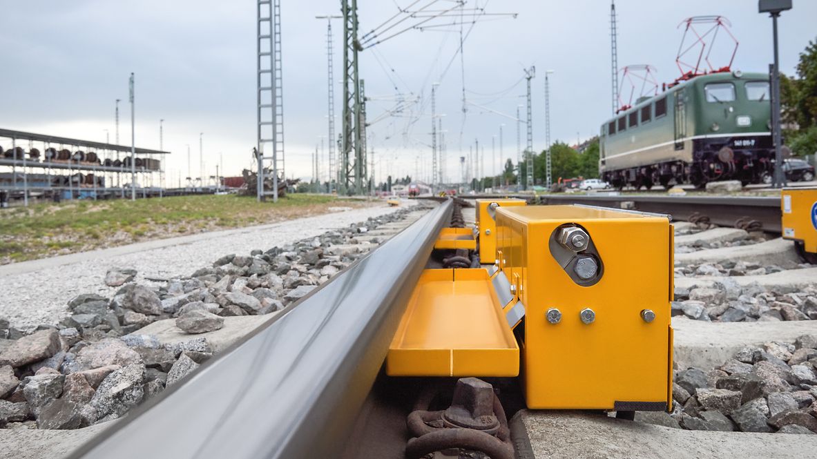 A rail lubrication system is installed in the track bed.