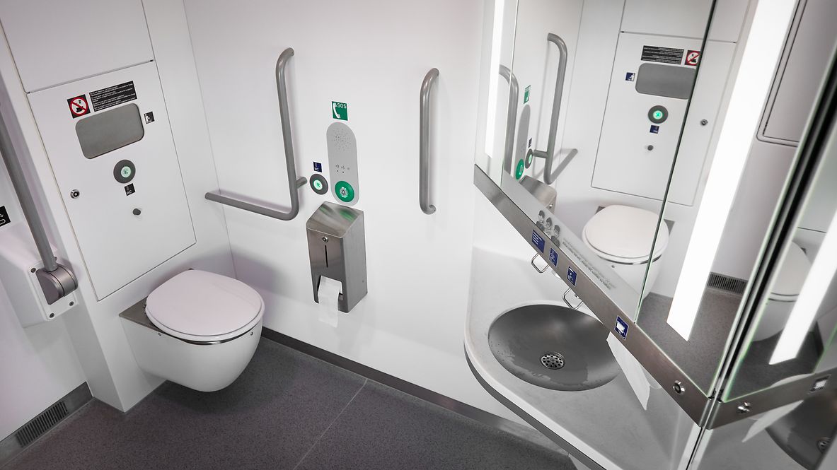 A water-saving toilet and a hand basin on the train.