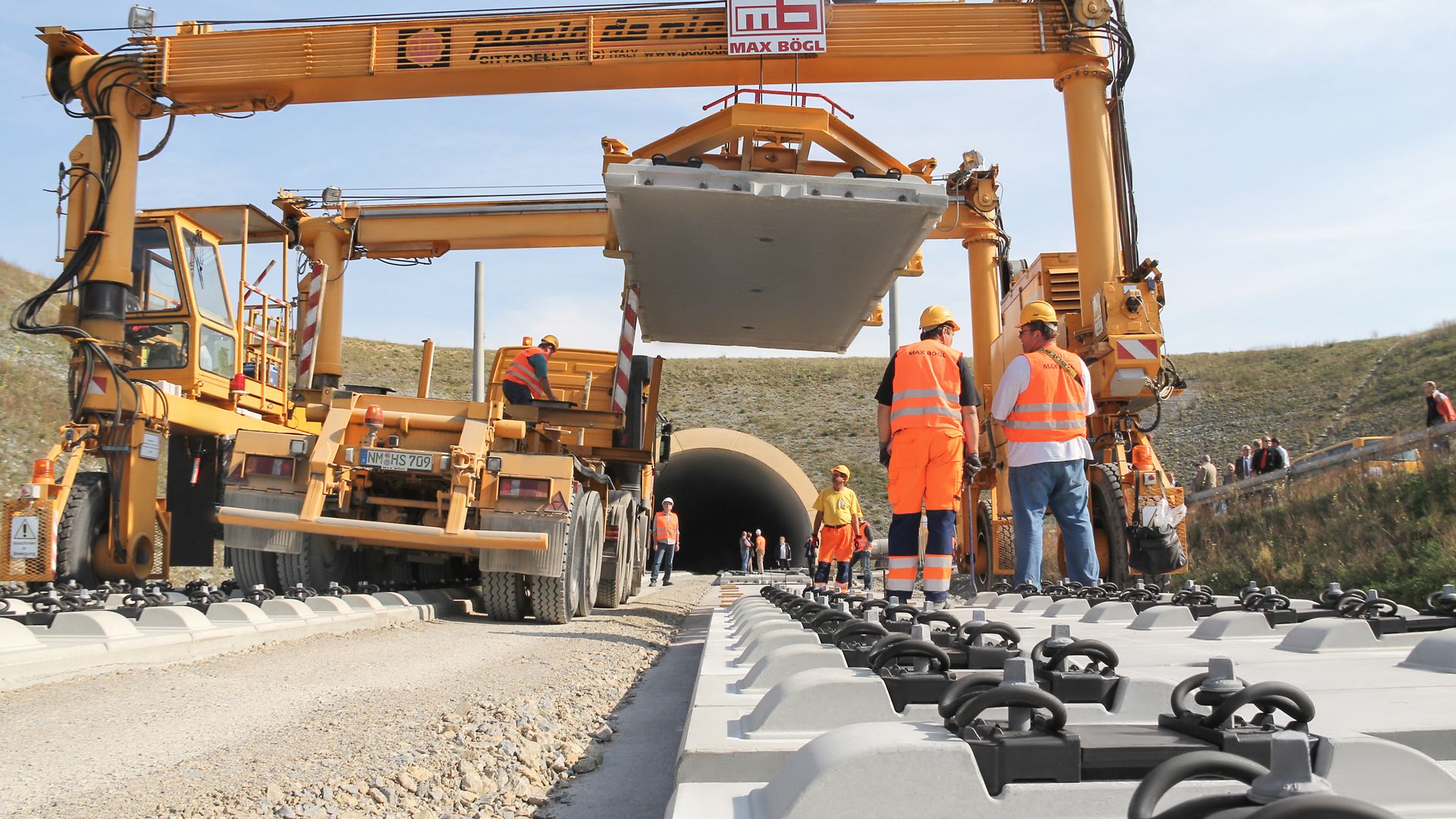 View of environmentally friendly rail construction work in front of a tunnel.