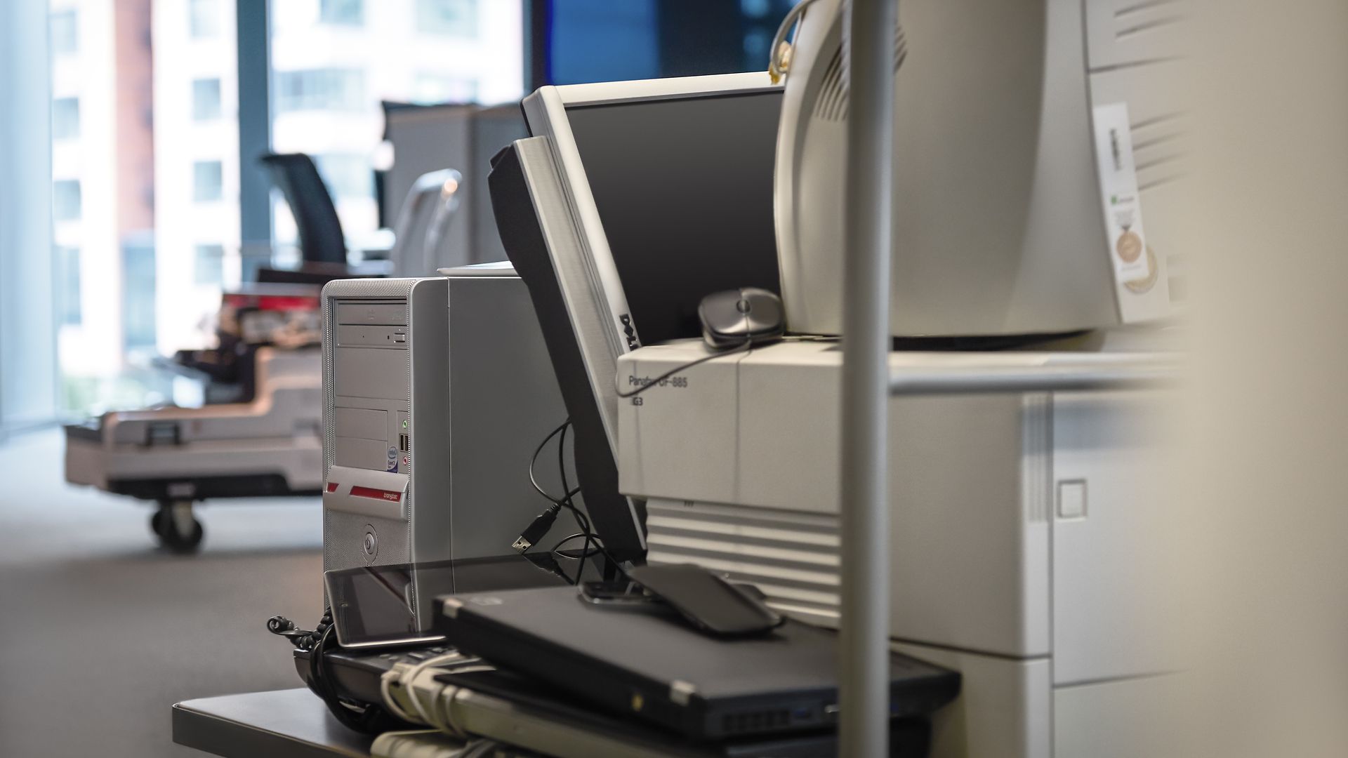 Discarded monitors, laptops, PCs and mobile devices in an office