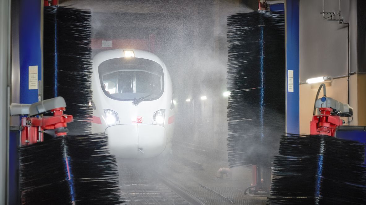 An ICE train is being cleaned in a washing facility.