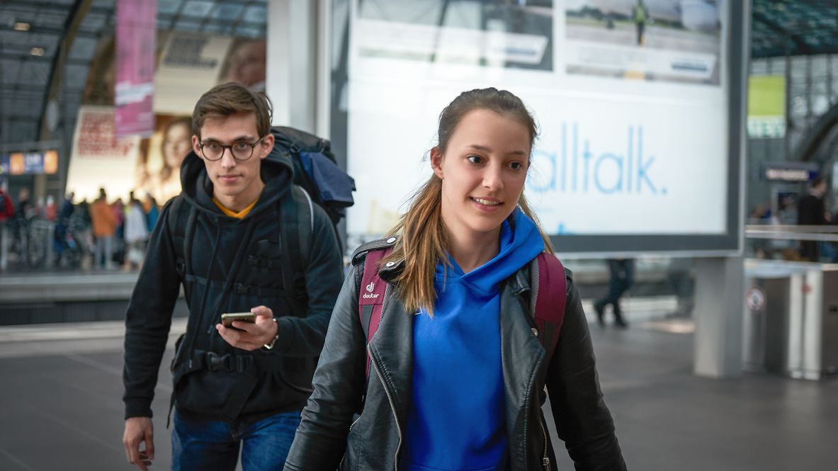 Two young travelers at the train station 