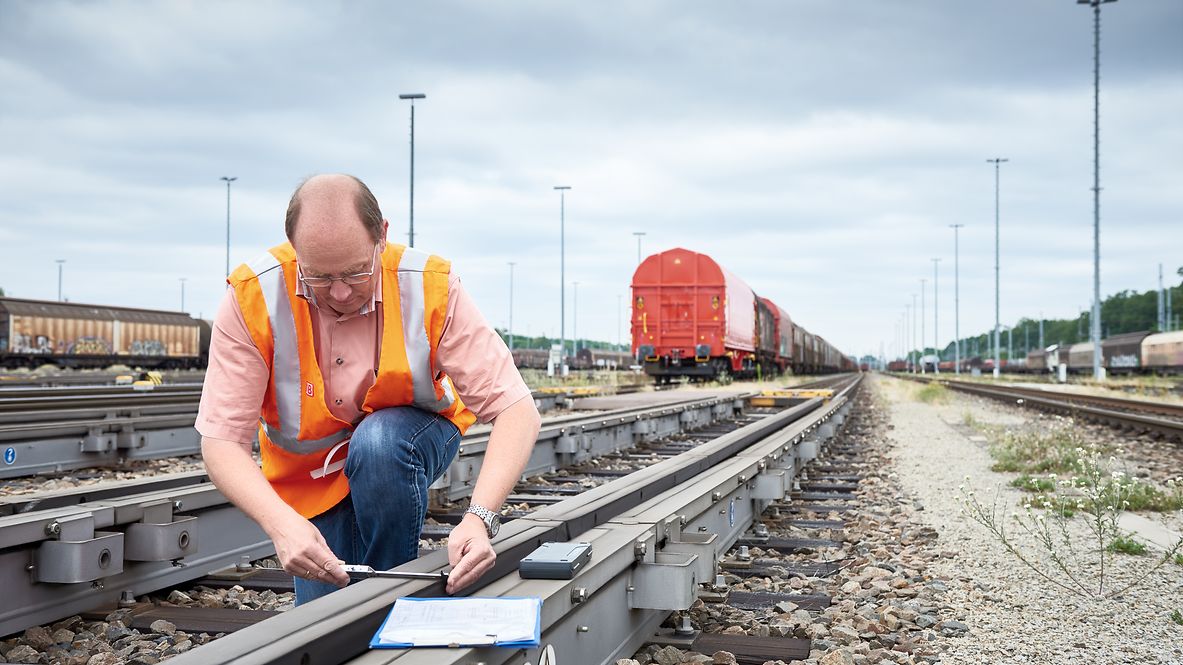An employee checks the brakes directly on the track. 