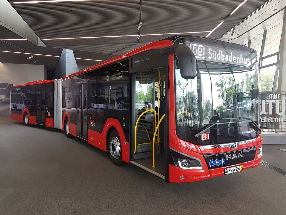 Red hybrid articulated bus from MAN with the lettering Südbadenbus in the display