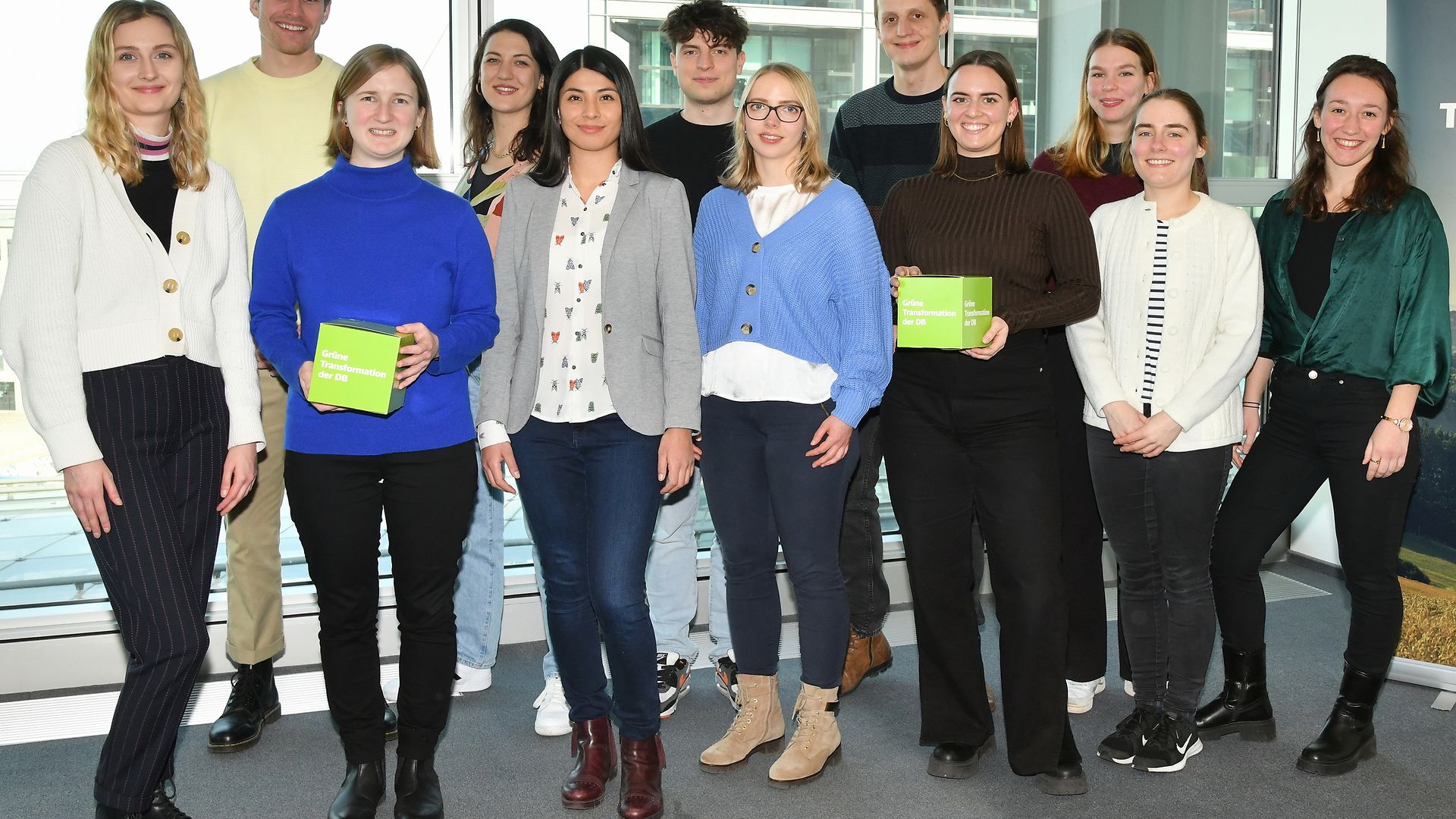 A group of young people standing together for a group picture.