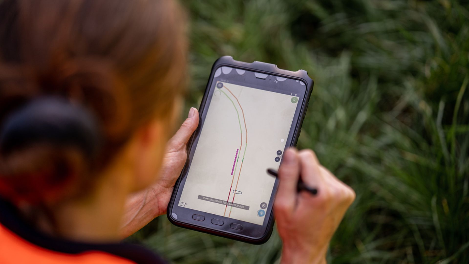 An employee using a tablet to put in data from the mapping.
