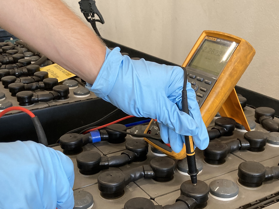 A man measures the energy status of the battery cells.
