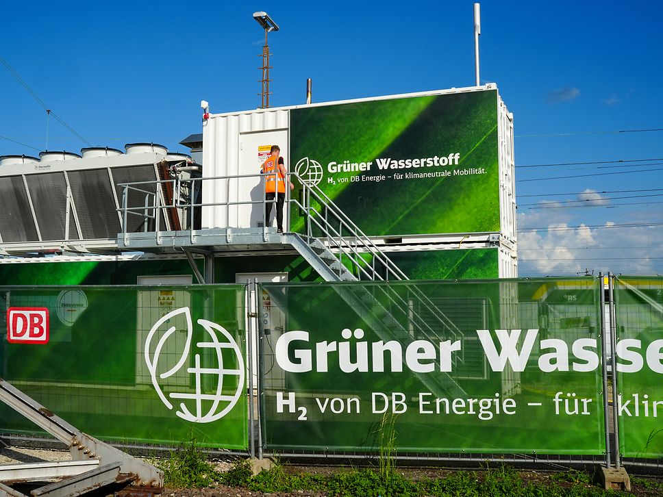 Green-labeled container buildings of the Tübingen Innovation Hub with advertising poster in the foreground