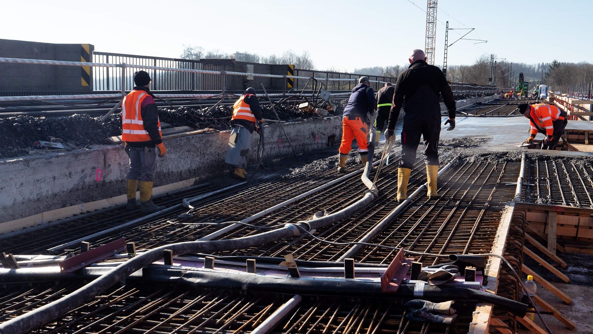 Construction workers are renovating a bridge.