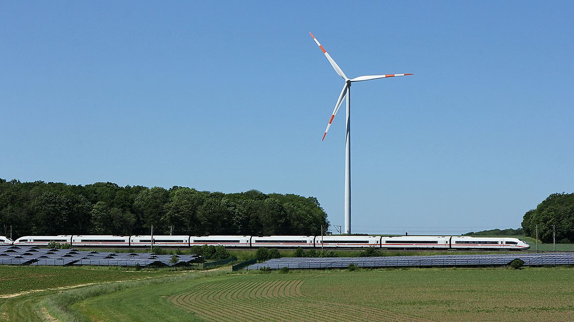 ICE passes solar park and wind turbine.